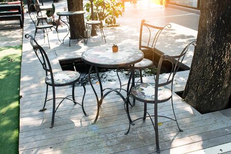 Wooden chairs and table in the gardenの写真素材