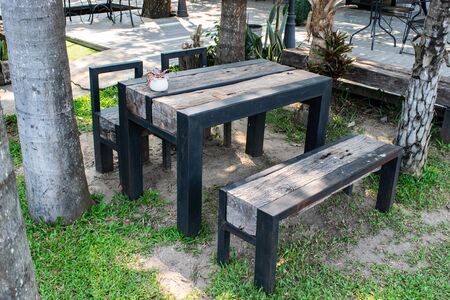 Wooden chairs and table in the gardenの写真素材