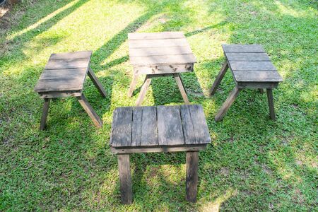 Wooden chairs and table in the gardenの写真素材