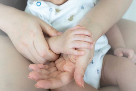 Mother holding her child's handの写真素材