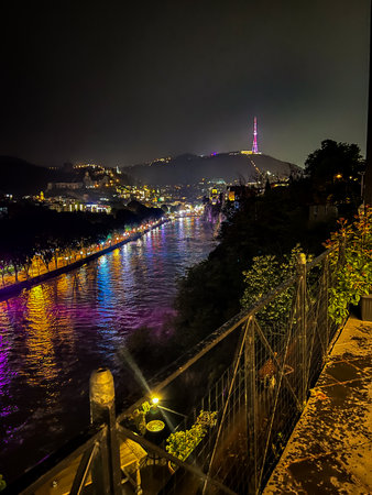 Panoramic view of the Kura river and Tbilisi television tower at night