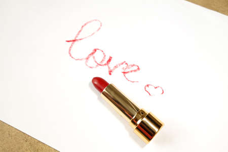 Red lipstick, word in English made with lipstick. Isolated on white                   の写真素材