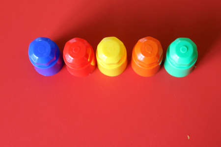 Buildable colored plastic blocks to play, build and organize on a red background as a concept of inclusion, diversity and pluralityの写真素材