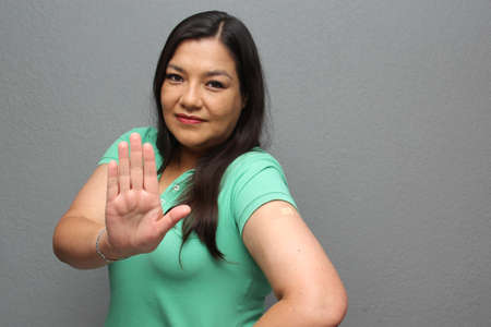 Adult Latina woman shows her arm that just received the  vaccine in the new normal of the pandemicの写真素材