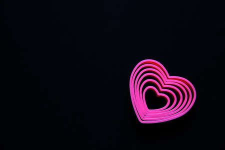 pink hearts on black background for valentine's day advertising bannerの写真素材