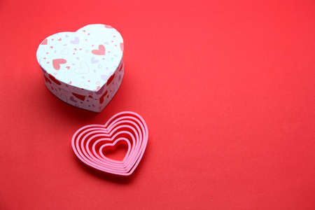 teddy bear, box of chocolates and pink hearts with ribbon on red background, Valentine's Day gifts, advertising bannerの写真素材