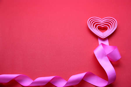 pink hearts with ribbon on red background, Valentine's day, advertising bannerの写真素材