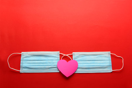valentine in pandemic by covid-19, protection mask clinical use and heartsの写真素材