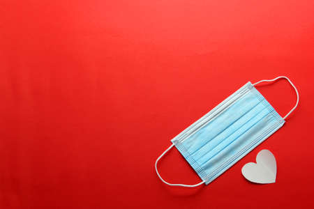 Tri-layer protective mask for clinical use with white hearts on a red background