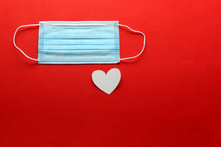 Tri-layer protective mask for clinical use with white hearts on a red background
