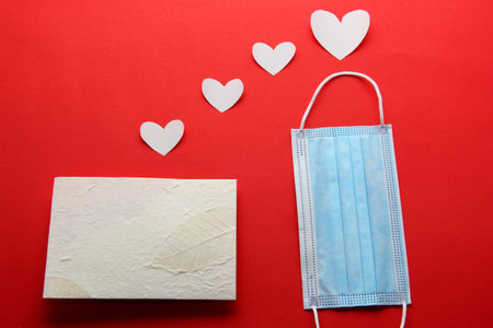 Valentine's Day in pandemic by covid-19, messages and love letters with protection mask clinical use and pink heartsの写真素材