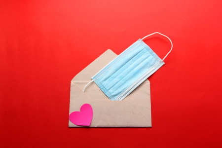 Valentine's Day in pandemic by covid-19, messages and love letters with protection mask clinical use and pink heartsの写真素材