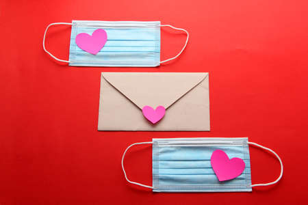 Valentine's Day in pandemic by covid-19, messages and love letters with protection mask clinical use and pink heartsの写真素材