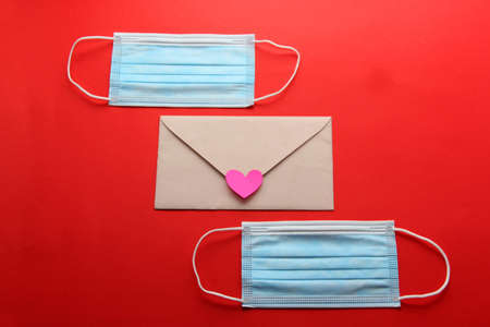 Valentine's Day in pandemic by covid-19, messages and love letters with protection mask clinical use and pink heartsの写真素材