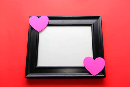 portrait frame with pink hearts on red background, gift of Valentine's Day