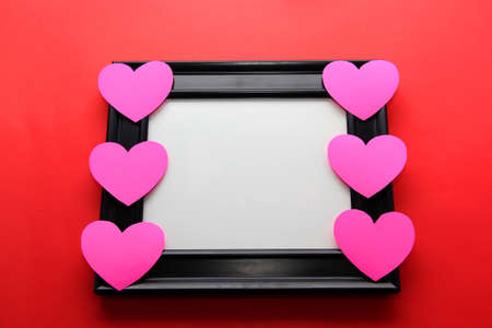 portrait frame with pink hearts on red background, gift of Valentine's Dayの写真素材