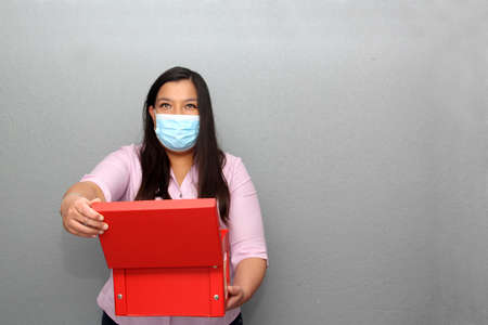 Valentine's day in contingency covid-19. latin woman with protection mask clinical use and red...