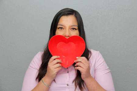 Valentine's Day. latin woman with red heartの写真素材