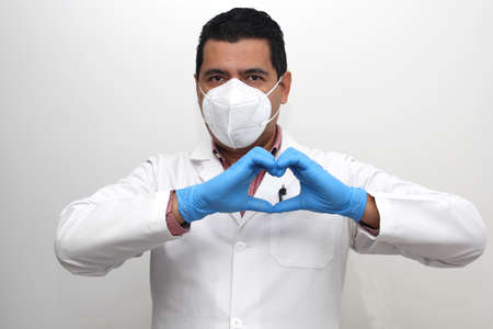 Valentine's Day. doctor with protection mask, latex gloves and gown, heart
