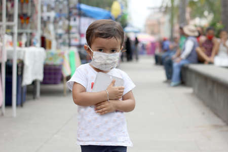2-year-old Latin girl with protective mask new normal covid-19の写真素材