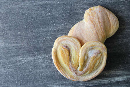 Mexican sweet bread on vintage gray table. Shell, concha, cupcake, shortbread, bow tie, mustache,...