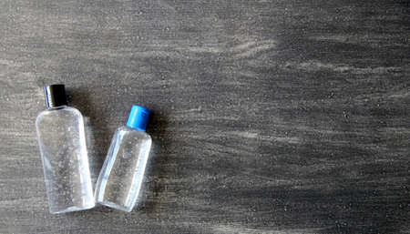 Antibacterial alcohol disinfectant gel 2 presentations on vintage gray background, covid prevention