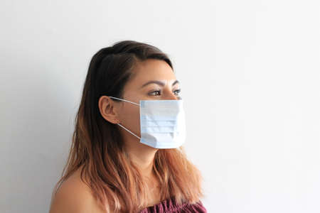 latin woman with protection mask clinical use for pandemic covid-19の写真素材
