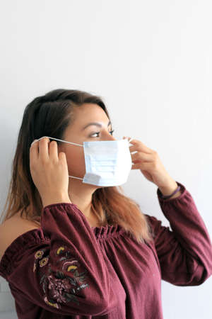 latin woman with protection mask clinical use for pandemic covid-19
