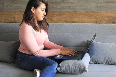 Latina woman doing home office with protection mask in covid pandemic