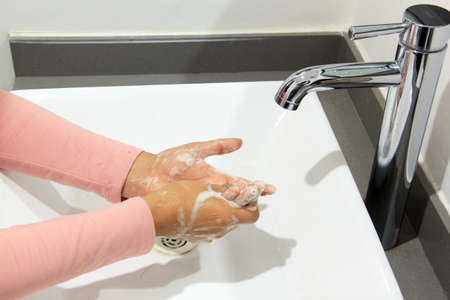 Personal hygiene, female hands wash and disinfect hands, covid-19 protectionの写真素材