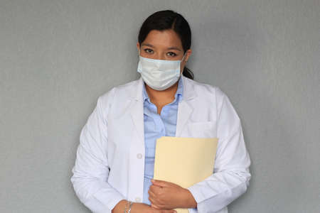 Latina doctor woman with white coat and protection mask clinical use for covid-19 pandemic