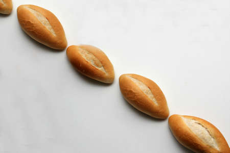 Delicious, fresh, fluffy, crunchy, hot, freshly made bun mexican bread, french bread, white, loaf baked with wheat flour on white background ready to eatの写真素材
