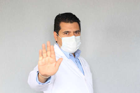 Latino doctor with white coat and protective mask to prevent covid-19, new normal