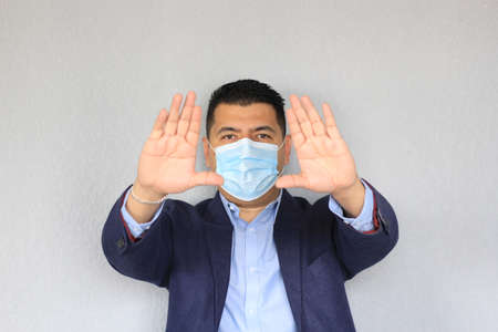 Formal adult latin man with protection mask, new normal covid-19の写真素材