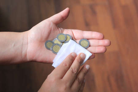 hygiene at home, clean and disinfect money with an antibacterial wipe, virus preventionの写真素材