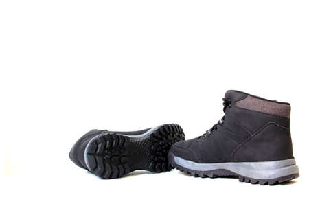 Hiking boots for men or women who want to do mountain walks with a firm anti-slip sole that gives stability and freedom of movement for adventure on vacation or weekendの写真素材