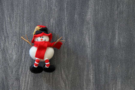 set of snowmen christmas figures for christmas tree decoration on vintage gray wooden background