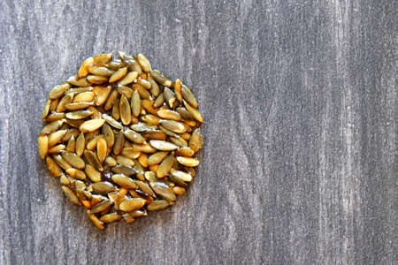 the palanquetas, alegrias and dulce de leche, typical Mexican candies made with amaranth, seeds and peanuts on gray vintage wooden backgroundの写真素材