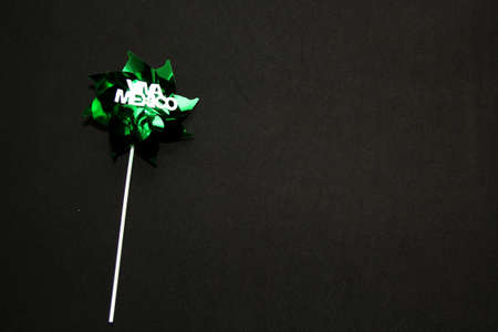 Tricolor decorative ornaments pinwheels for Mexican parties in green, white and red on a black backgroundの写真素材