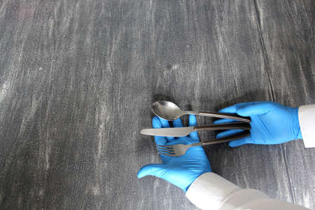 Montage view of plates and cutlery for eating on vintage gray table.with the pretense of new normality due to covid-19 virusの写真素材