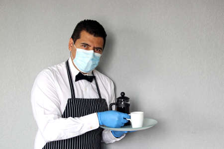 Latin waiter man serving coffee and food, working with face masks, new normal for covid-19 virus