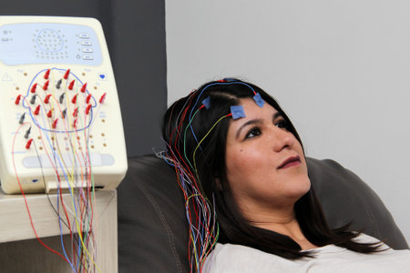 Latin adult woman is a patient in the neurology specialty office and an electroencephalogram study...