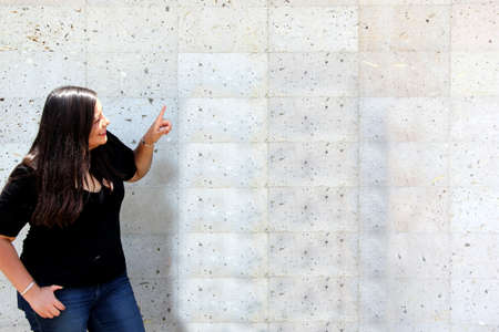 Latin adult woman dressed in black blouse happy next to blank space to display messages of harmony...
