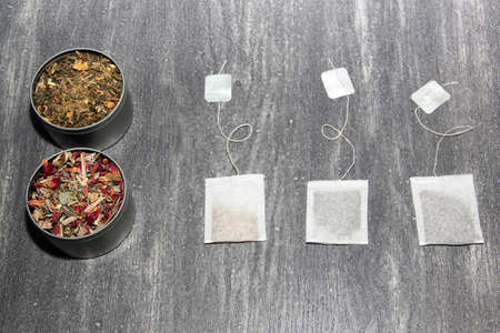 Herbal tea making tools: glass cup, infuser, spoon, dried dehydrated herb, sachets, to cure diseases and relaxationの写真素材