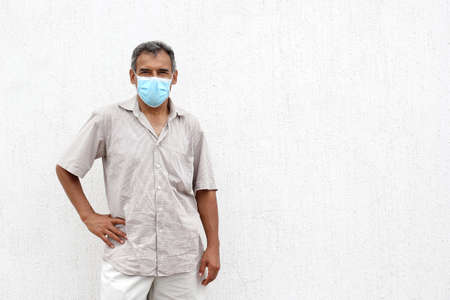 Latino elderly with protective face masks on white wall background, new normal covid-19の写真素材