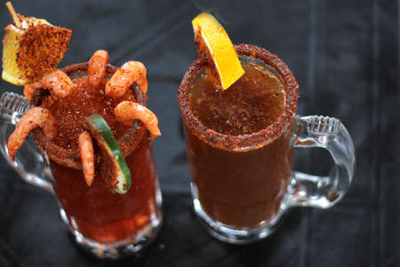 Micheladas served on an outdoor table, it is a Mexican alcoholic drink that is prepared by mixing...