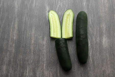 Fresh and juicy green cucumbers ready to cut in the kitchen and eat in saladの写真素材