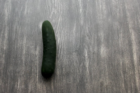 Fresh and juicy green cucumbers ready to cut in the kitchen and eat in saladの写真素材
