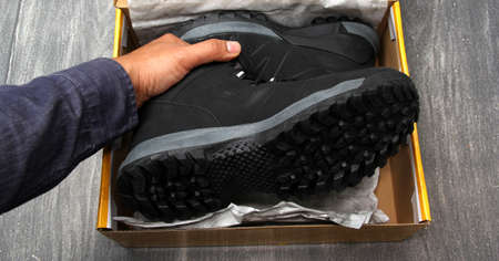 Brand new black hiking boots in the online shopping box just received at home by home delivery