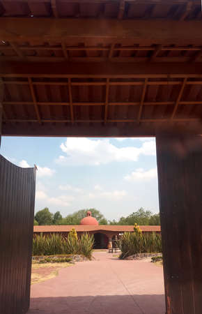 Colonial farm and country house, stone and red brick construction with arches and green grass gardenの写真素材